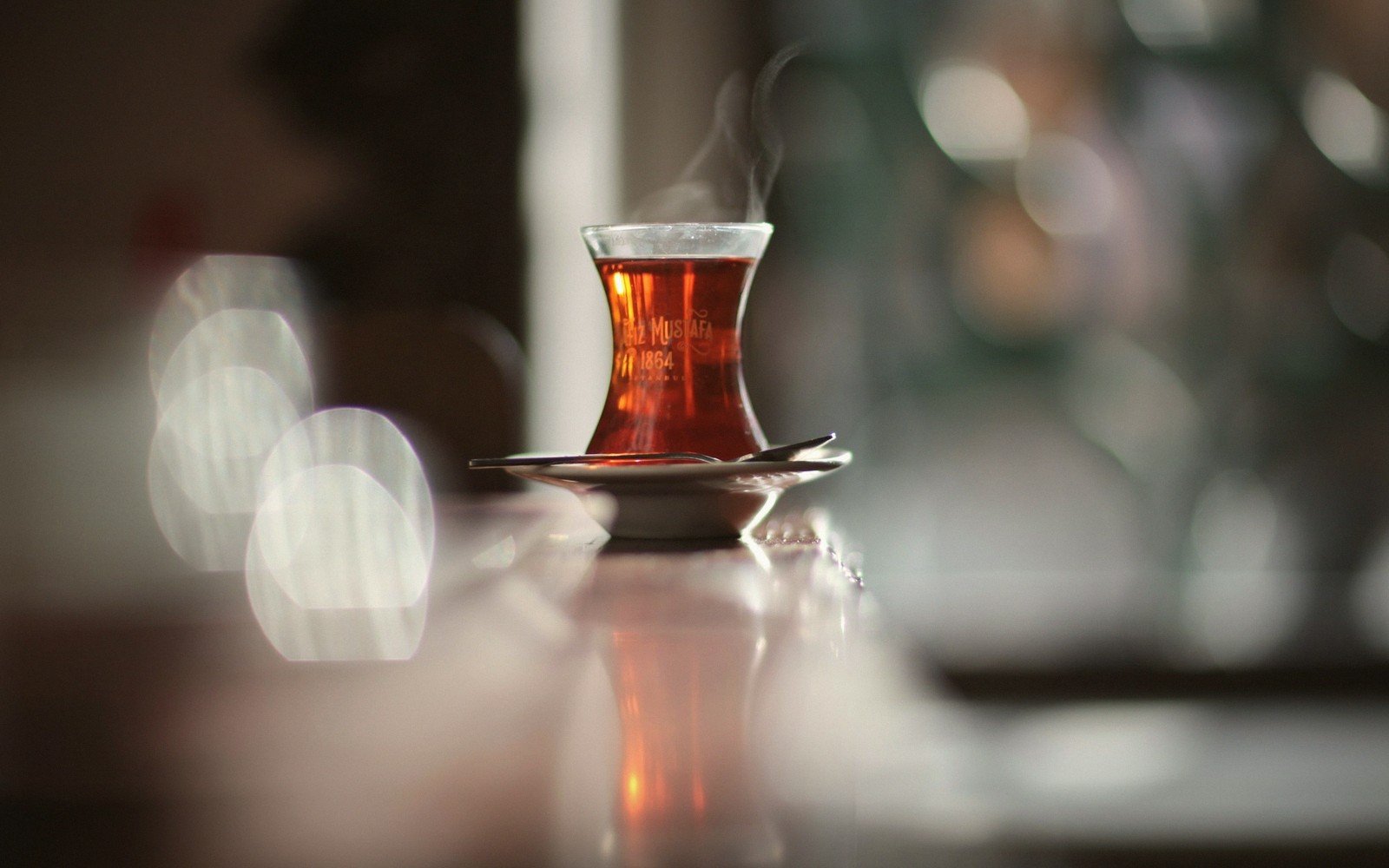 a tulip glass of çay on a saucer